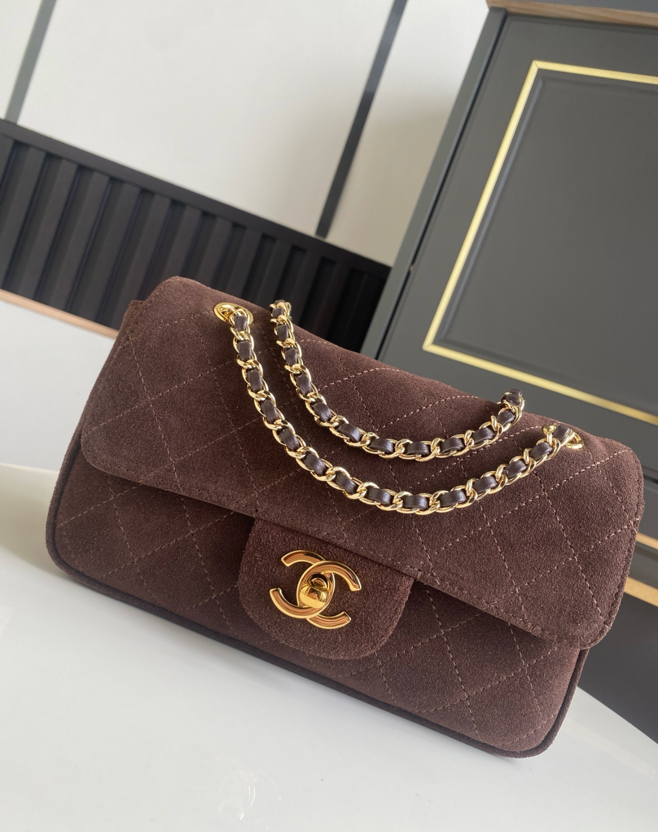 Chocolate brown quilted replica handbag with a gold-tone chain